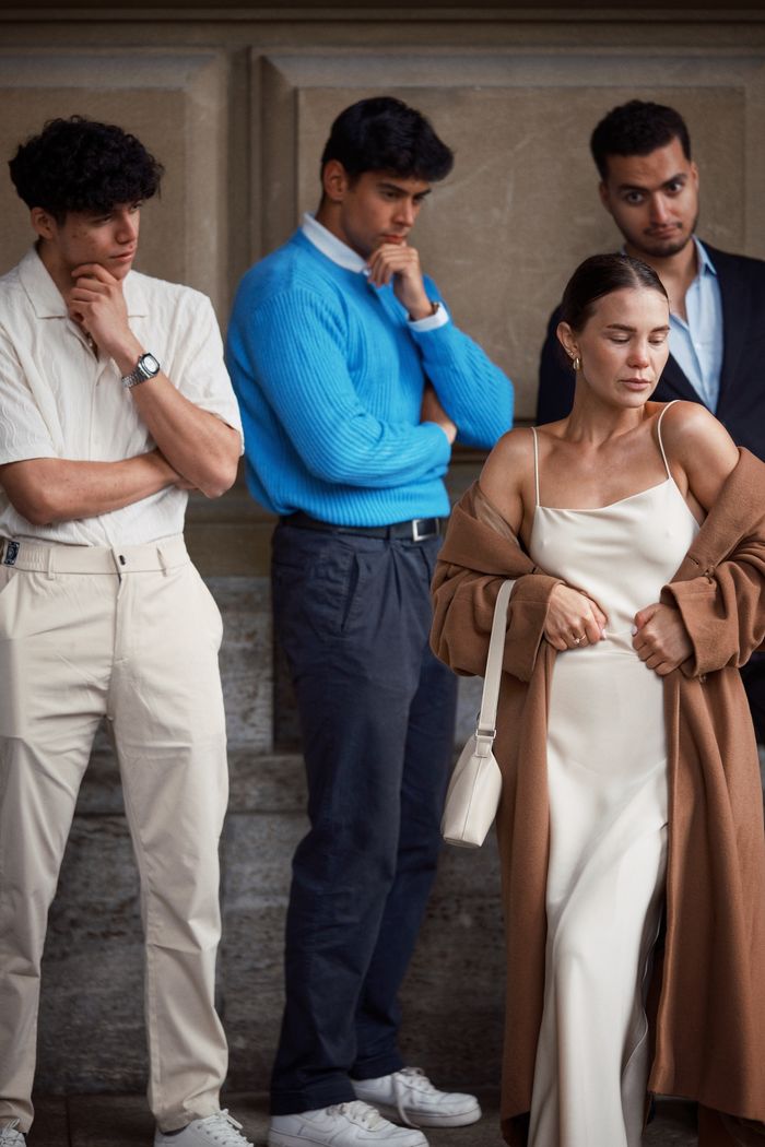 Services A stylish group of young adults posing with thoughtful expressions in an urban setting.